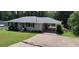 Exterior view of the home showing the front yard, driveway, covered parking, and landscaping at 3844 Davis St, Suwanee, GA 30024
