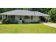 Charming single story home with a well maintained lawn, beautiful shrubbery, and convenient covered parking at 3844 Davis St, Suwanee, GA 30024
