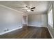 Neutral living room with hardwood floors, ceiling fan, white trim, and a window at 3844 Davis St, Suwanee, GA 30024