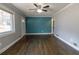 Bright living room with hardwood floors, gray walls, a blue accent wall and natural light at 3844 Davis St, Suwanee, GA 30024