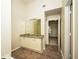 Bright bathroom with double vanity, granite counters, and a view into another room at 4530 Talon Way, Douglasville, GA 30135