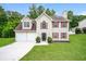 Charming two-story home with a manicured lawn and a two-car garage at 4530 Talon Way, Douglasville, GA 30135