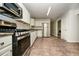 Kitchen featuring granite countertops, stainless steel appliances, and tile floors at 4530 Talon Way, Douglasville, GA 30135