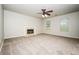 Bright living room with a fireplace, ceiling fan, and large windows providing natural light at 4530 Talon Way, Douglasville, GA 30135