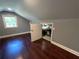 Finished attic space with gray walls, hardwood floors, a window, and a door to a storage room at 5191 Nw Emory Nw St, Covington, GA 30014