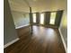 Finished basement with wood floors, neutral paint, and natural light from the sliding glass doors at 5191 Nw Emory Nw St, Covington, GA 30014