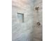 Modern shower with decorative tiling and built-in shelving at 5191 Nw Emory Nw St, Covington, GA 30014