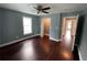 Spacious bedroom with gleaming hardwood floors, a ceiling fan, and a bright window for lots of natural light at 5191 Nw Emory Nw St, Covington, GA 30014