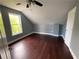Bedroom with ceiling fan, window, dark wood floors, fresh paint and new trim at 5191 Nw Emory Nw St, Covington, GA 30014
