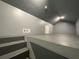 Large bonus room with angled walls, gray paint, and carpeted stairs at 5191 Nw Emory Nw St, Covington, GA 30014
