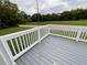 Enjoy outdoor living on this gray wood deck with white railing overlooking the beautiful lawn at 5191 Nw Emory Nw St, Covington, GA 30014