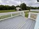 New deck painted in grey with new white rails in backyard with lush green grass at 5191 Nw Emory Nw St, Covington, GA 30014