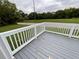 New deck painted in grey with new white rails in backyard with green grass at 5191 Nw Emory Nw St, Covington, GA 30014