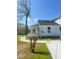 Inviting exterior view with a walkway leading to a charming light blue home and covered porch at 5191 Nw Emory Nw St, Covington, GA 30014
