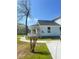 Inviting home showcasing a lovely porch, complemented by a well-maintained green lawn at 5191 Nw Emory Nw St, Covington, GA 30014