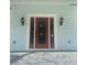 Elegant front door with decorative glass, framed by sconces, adding charm to the home's entrance at 5191 Nw Emory Nw St, Covington, GA 30014