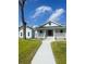 Charming light blue home featuring a welcoming front porch and a well-manicured lawn at 5191 Nw Emory Nw St, Covington, GA 30014