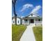 Charming light blue home with inviting front porch and well-maintained lawn on a beautiful day at 5191 Nw Emory Nw St, Covington, GA 30014