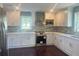 Modern kitchen with white cabinetry, stainless steel appliances, and stylish backsplash at 5191 Nw Emory Nw St, Covington, GA 30014
