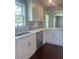 Bright kitchen featuring white cabinets, stainless steel appliances, and a stylish backsplash at 5191 Nw Emory Nw St, Covington, GA 30014