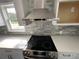 Close up of range and hood in a modern kitchen at 5191 Nw Emory Nw St, Covington, GA 30014
