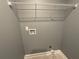 Utility room with overhead rack, grey paint and tile floor at 5191 Nw Emory Nw St, Covington, GA 30014