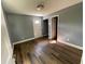 Bright living room with dark wood-look flooring and white trim, featuring a front door at 5191 Nw Emory Nw St, Covington, GA 30014