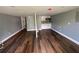 Spacious living room with hardwood floors, natural light, and mini-kitchen at 5191 Nw Emory Nw St, Covington, GA 30014