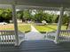 Relaxing porch area with a picturesque view, framed by elegant white pillars and railings at 5191 Nw Emory Nw St, Covington, GA 30014