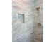 Shower stall featuring light marbled tile, a built-in niche, and a modern showerhead at 5191 Nw Emory Nw St, Covington, GA 30014