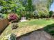 Landscaped backyard with a well-maintained lawn, privacy fence, and a charming bench for enjoying the outdoors at 108 Hickory Run, Canton, GA 30115