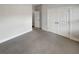Neutral bedroom with plush gray carpet, white walls, and a closet with double doors at 108 Hickory Run, Canton, GA 30115