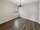 Dining room with hardwood floors, base trim, one window, and an elegant light fixture at 108 Hickory Run, Canton, GA 30115