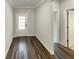 Bright entryway with wood laminate flooring, a white front door, and neutral paint at 108 Hickory Run, Canton, GA 30115