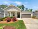 Charming single-Gathering home with a well-manicured lawn, blooming flowerbeds, and a convenient two-car garage at 108 Hickory Run, Canton, GA 30115