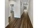 Hallway with wood laminate floors leading to other rooms, neutral paint, and modern trim at 108 Hickory Run, Canton, GA 30115