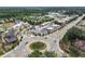 Aerial view showcasing the community's shopping center and roundabout, with lush greenery at 1210 Mayfield Rd, Milton, GA 30009