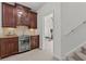 Basement bar area features custom cabinetry, beverage refrigerator, and granite countertops, perfect for entertaining guests at 1345 Hilltop Overlook Dr, Marietta, GA 30062