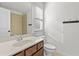 Bathroom featuring neutral tiling, a granite vanity countertop, and a view to the commode and shower at 1345 Hilltop Overlook Dr, Marietta, GA 30062