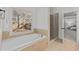 Bright bathroom featuring a separate shower, soaking tub, and large windows at 1345 Hilltop Overlook Dr, Marietta, GA 30062