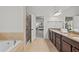 Bathroom offers double sinks, tiled floors, a separate shower, and a soaking tub at 1345 Hilltop Overlook Dr, Marietta, GA 30062