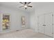 Neutral bedroom featuring two large windows, a ceiling fan, and a spacious closet with double doors at 1345 Hilltop Overlook Dr, Marietta, GA 30062