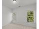 Bedroom with neutral walls and carpet, and a large window providing lots of natural light at 1345 Hilltop Overlook Dr, Marietta, GA 30062