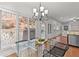 Bright breakfast nook with glass table, modern chairs, and large windows offering views of the landscaped backyard at 1345 Hilltop Overlook Dr, Marietta, GA 30062
