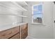 Closet features built in drawers and shelves along with a view to the outdoors through a window at 1345 Hilltop Overlook Dr, Marietta, GA 30062