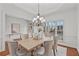 Bright dining room with a chandelier, a window view, neutral decor and seating for six at 1345 Hilltop Overlook Dr, Marietta, GA 30062