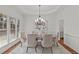Bright dining room with a chandelier, large windows, neutral décor and seating for six at 1345 Hilltop Overlook Dr, Marietta, GA 30062