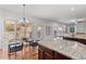 Open concept kitchen with stainless steel appliances, granite countertops and dark wood cabinets at 1345 Hilltop Overlook Dr, Marietta, GA 30062