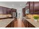 Kitchen with stainless steel appliances, dark wood cabinets, hardwood floors and granite countertops at 1345 Hilltop Overlook Dr, Marietta, GA 30062