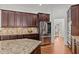 Modern kitchen with stainless steel appliances, granite countertops, and dark wood cabinets at 1345 Hilltop Overlook Dr, Marietta, GA 30062